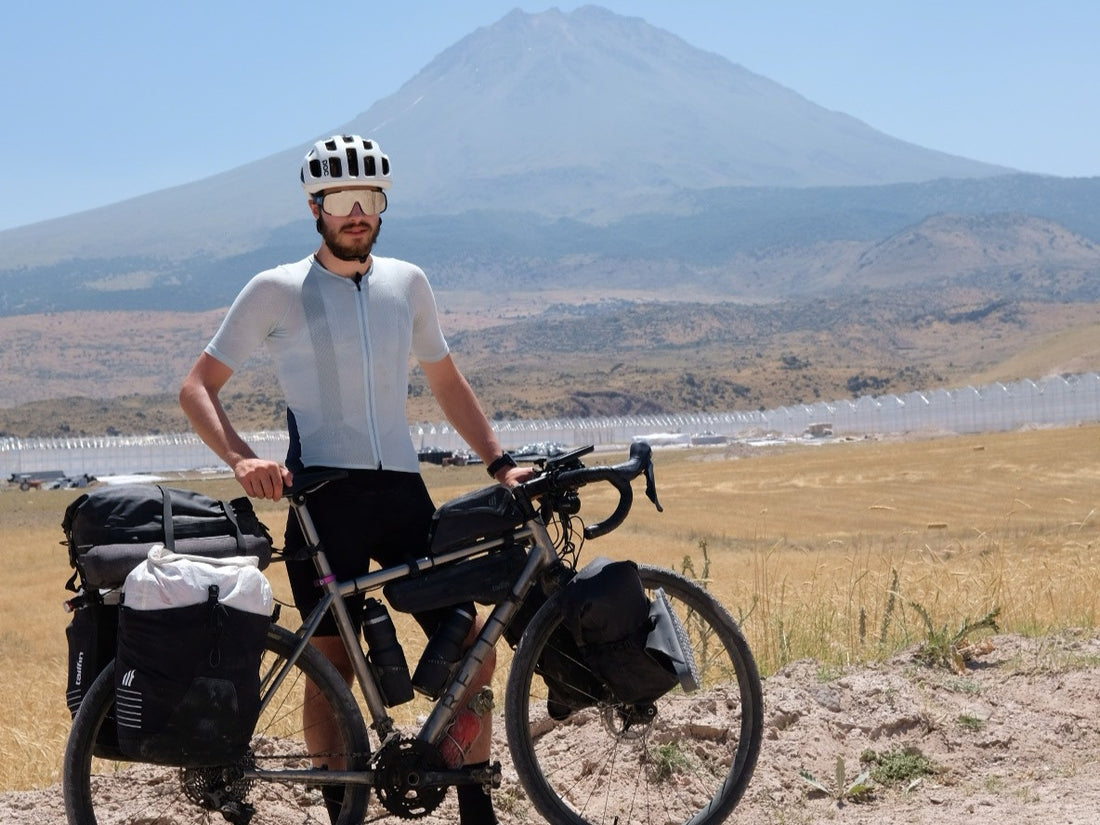 A Reilly titanium bike laden with bags with a mountain in the background