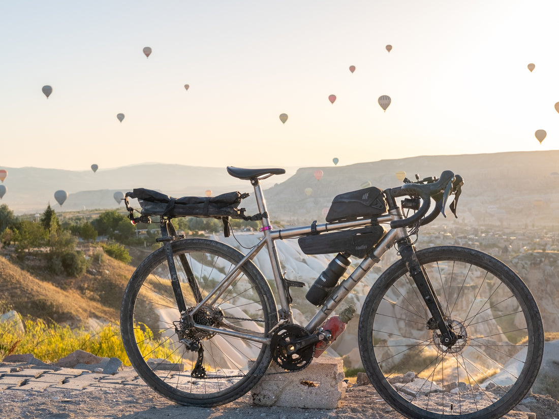 A titanium bike against a backdrop of hot air balloons.