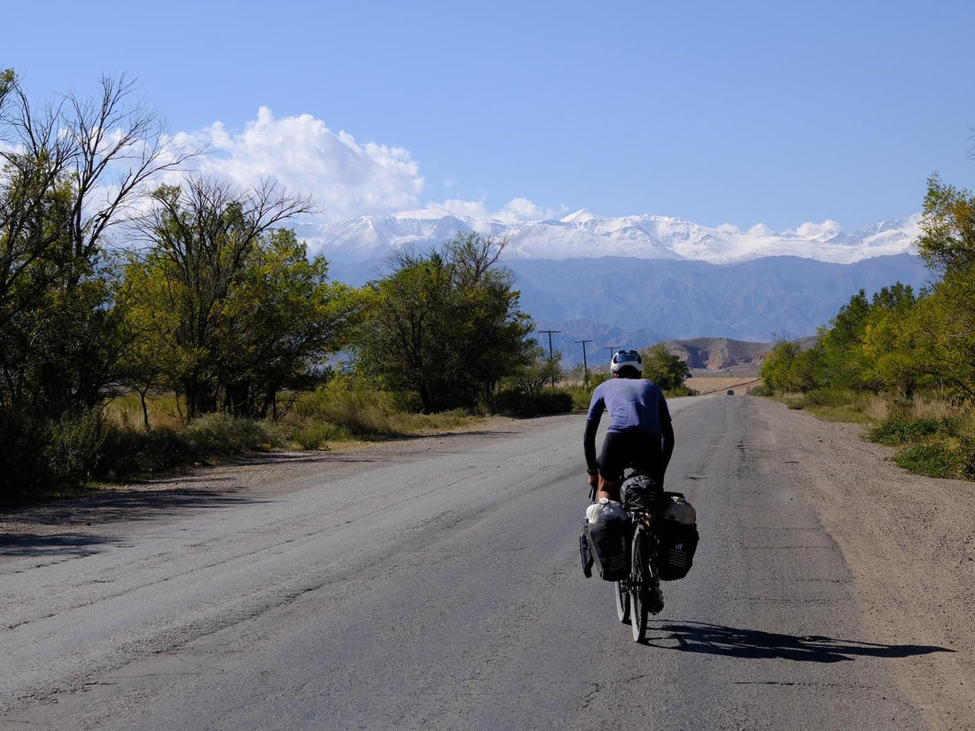 A cyclist goes along a gravel path.