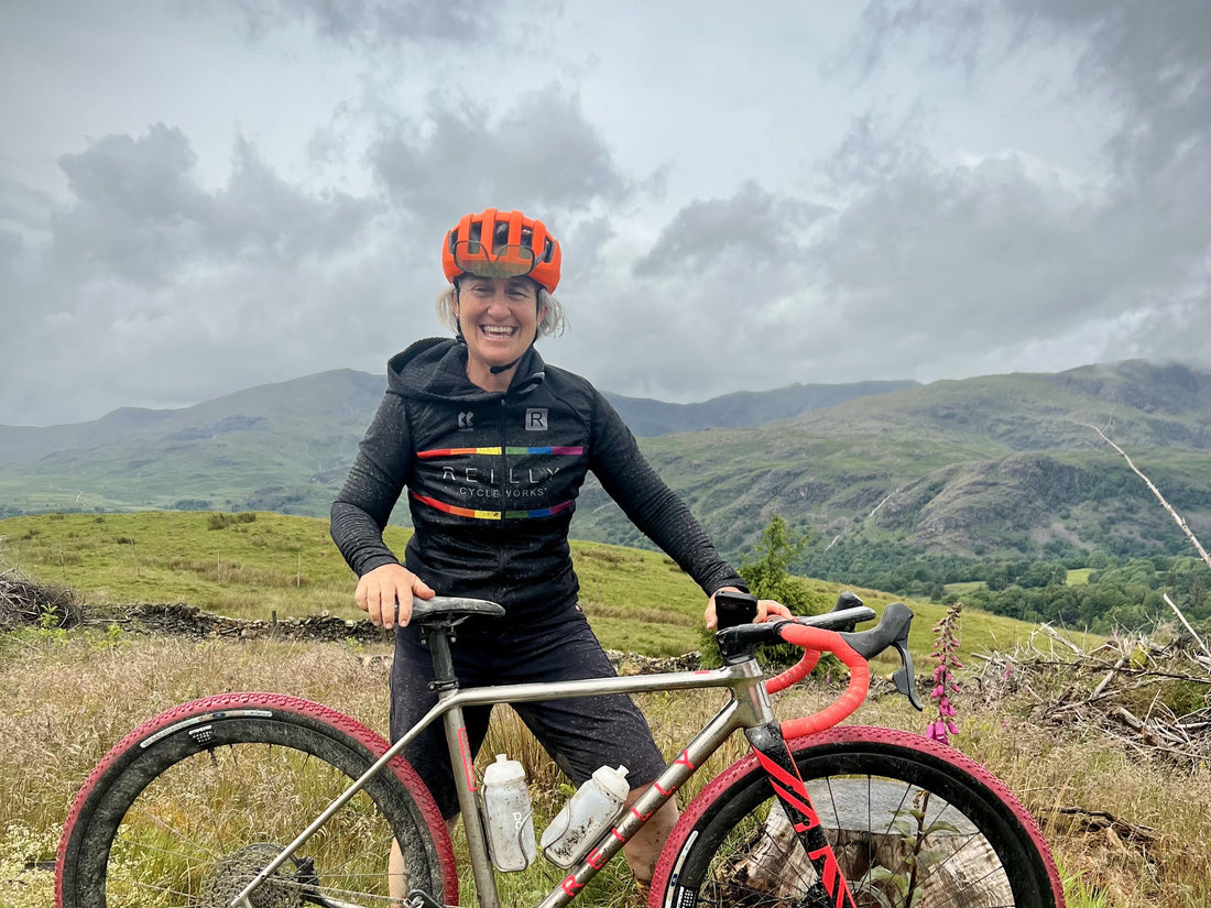 Person with a bicycle in a mountainous landscape