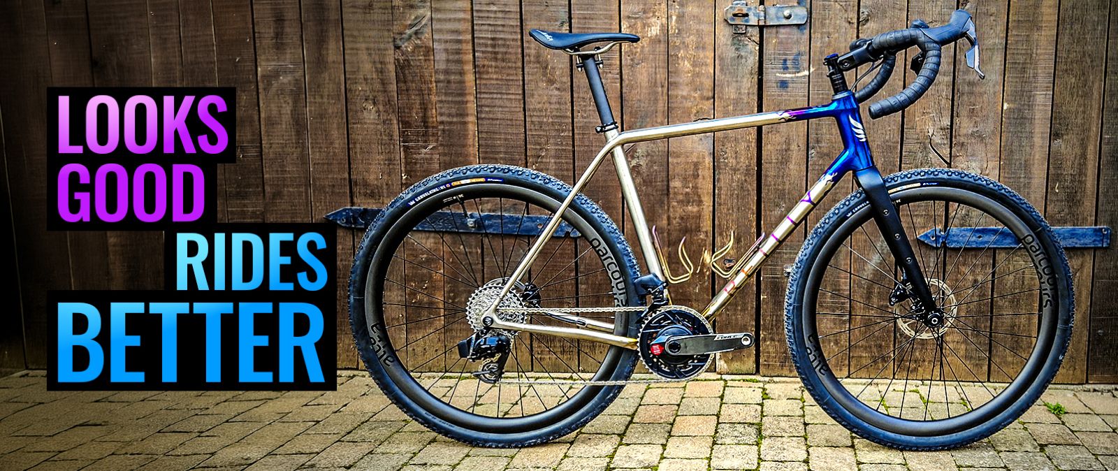 Bicycle leaning against a wooden wall with text 'Looks Good Rides Better' on a wooden floor.