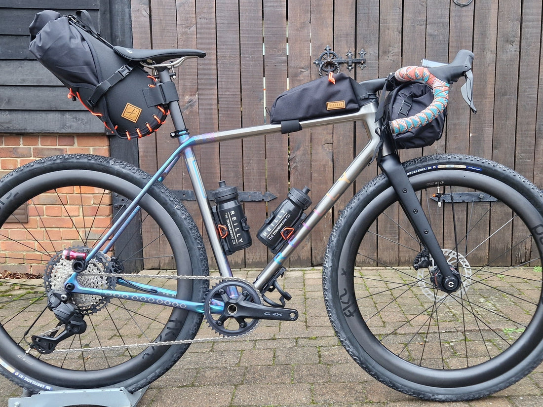 titanium bike against a wooden door.