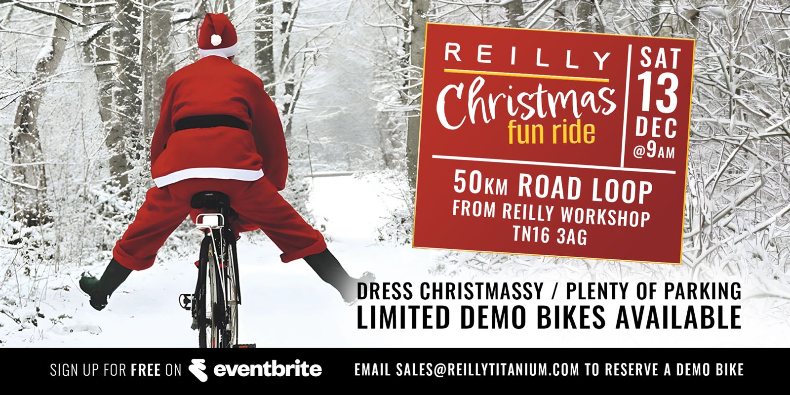 Person in red outfit riding a bike with a Christmas fun ride sign in the snow.