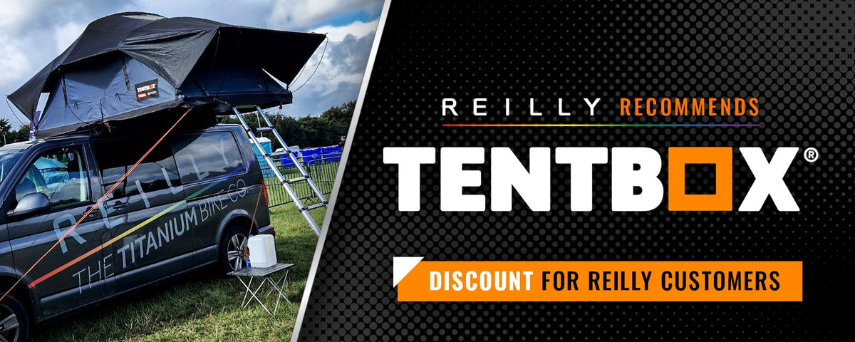 Promotional banner for TENTBOX tenting equipment, featuring a black rooftop tent mounted on a dark van on the left, and large black-and-orange branding text on the right reading 'REILLY RECOMMENDS TENTBOX' and 'DISCOUNT FOR REILLY CUSTOMERS'.