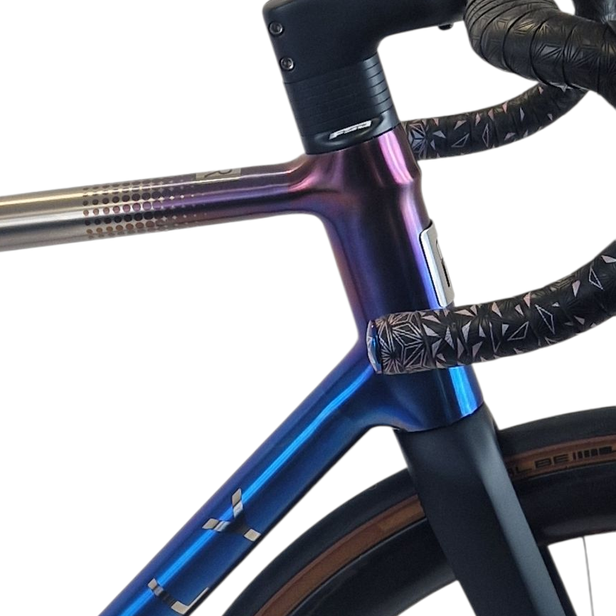 Close-up of a bicycle frame with a anodised dots finish on a white background.
