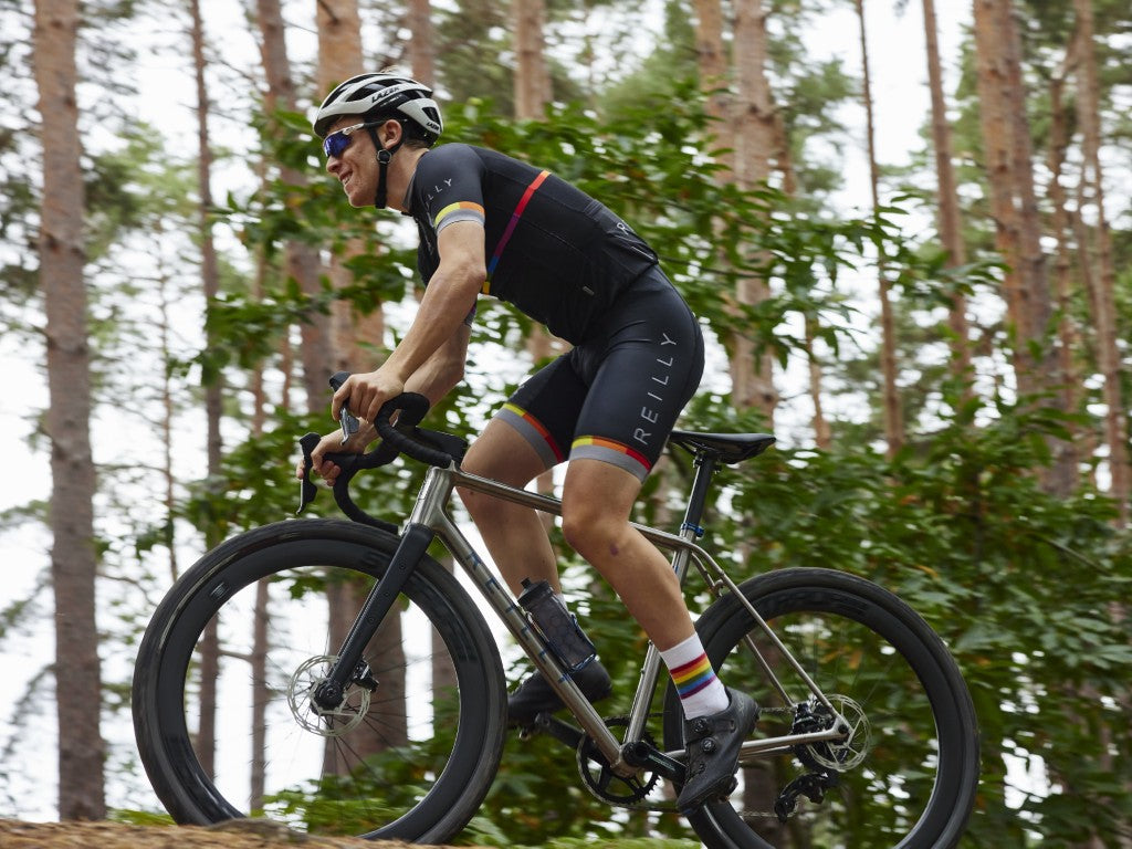 Titanium gravel bike cycling in a forest 