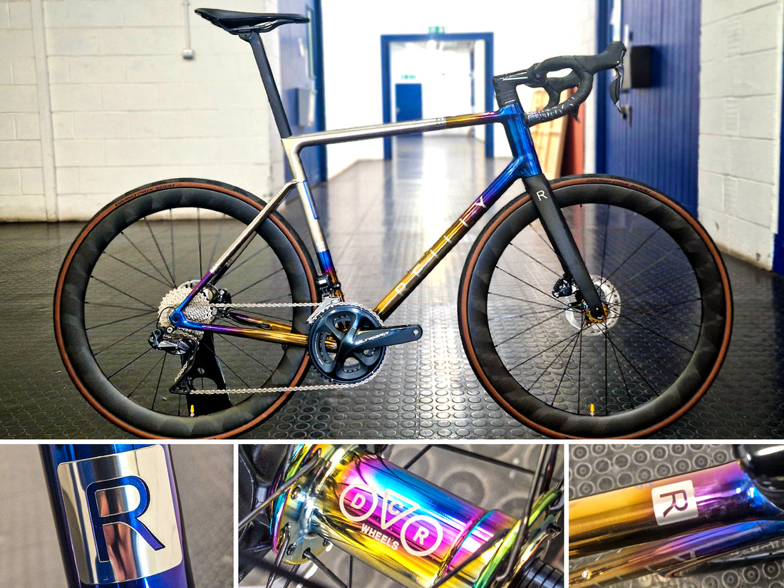 a bike stood in a warehouse with anodised touches.