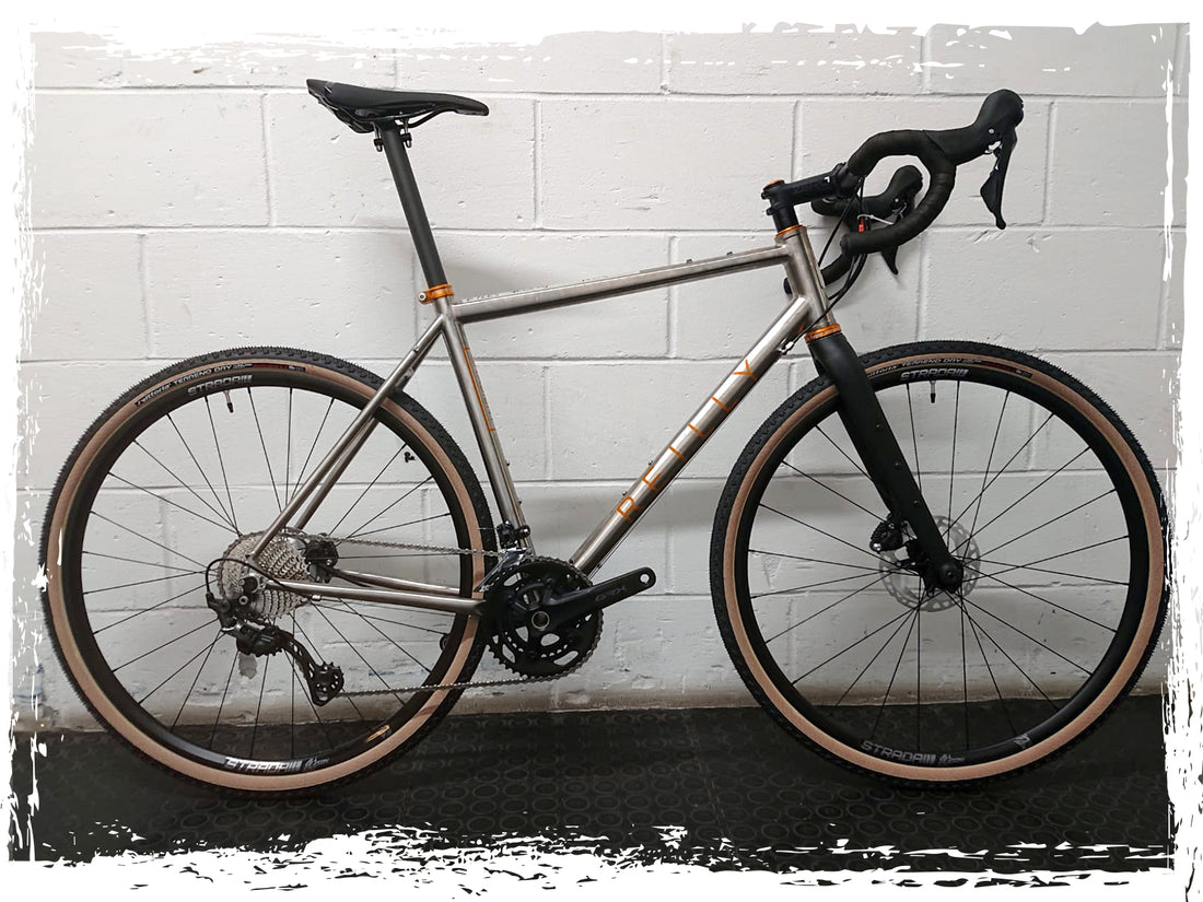 silver and orange titanium Reilly bike photographed
