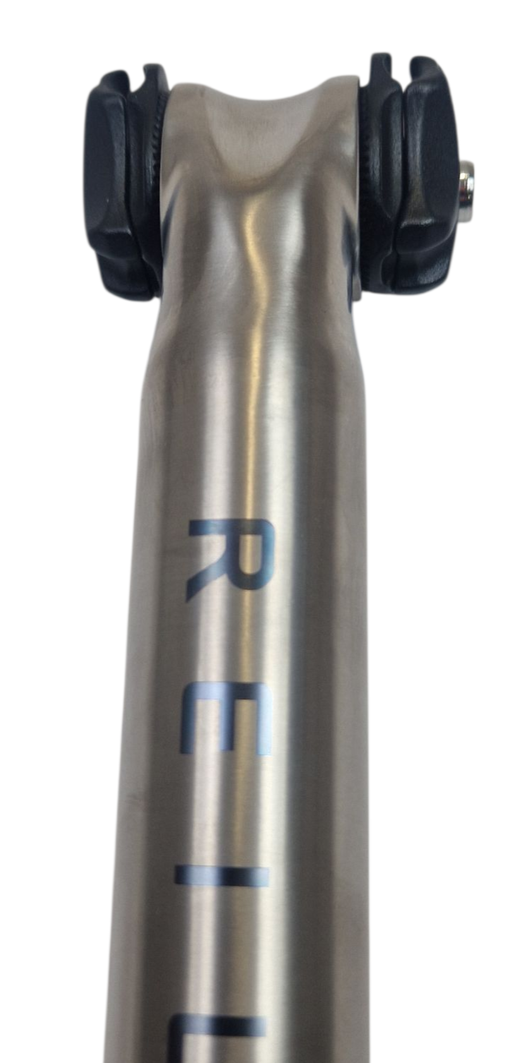 Titanium bicycle offset seat post with a smooth finish on a white background