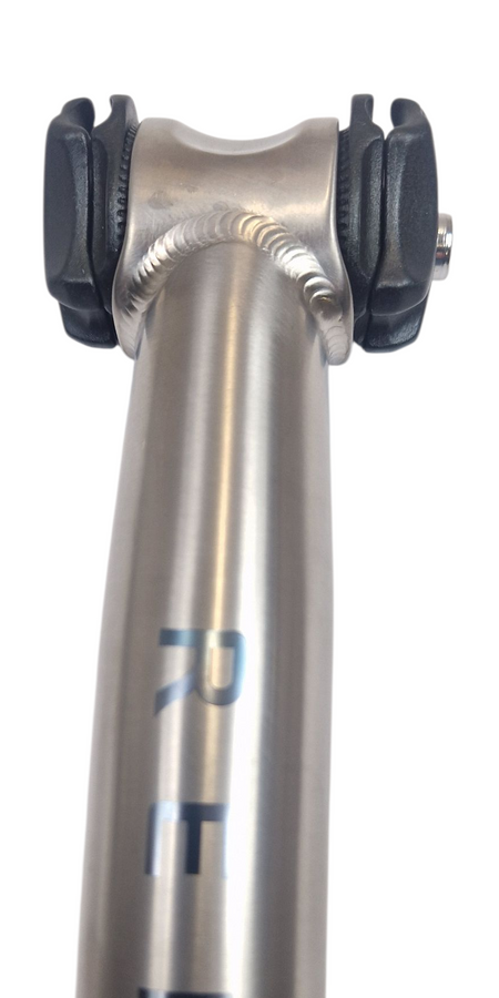 Titanium seat post with weld and black clamps on a white background
