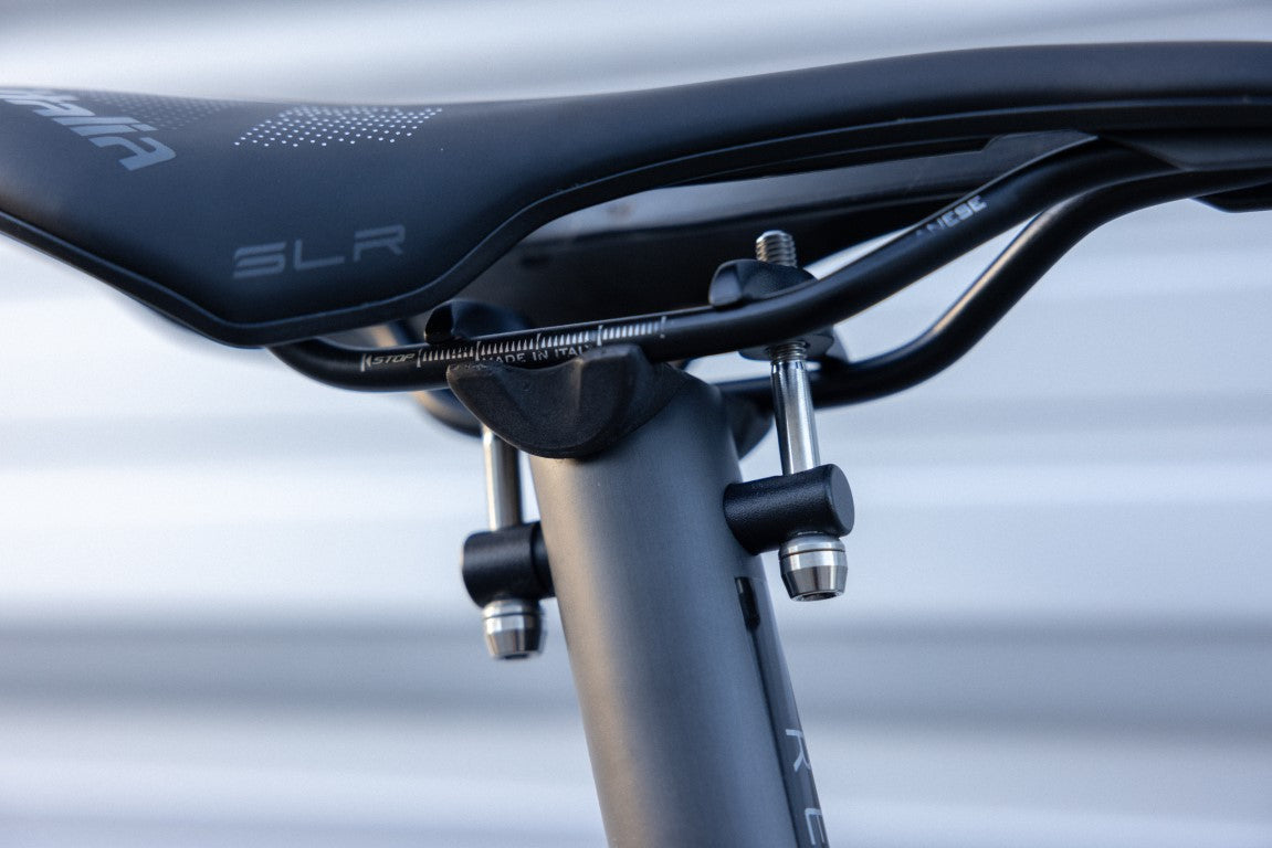 Side view of a saddle with alumium bolts.