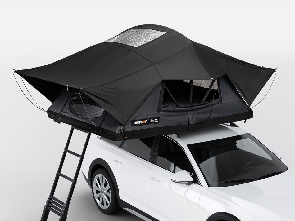 Black rooftop tent attached to a white SUV on a gray background