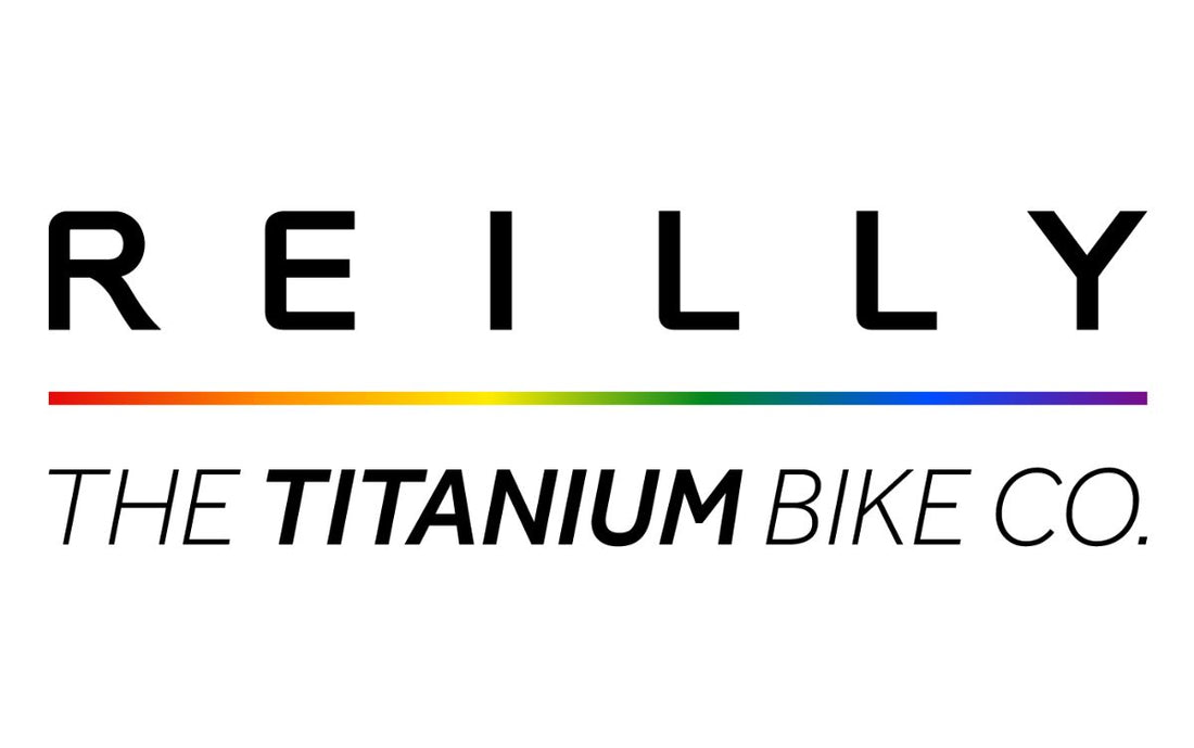 reilly the titanium bike co. logo with a rainbow streak in the middle.