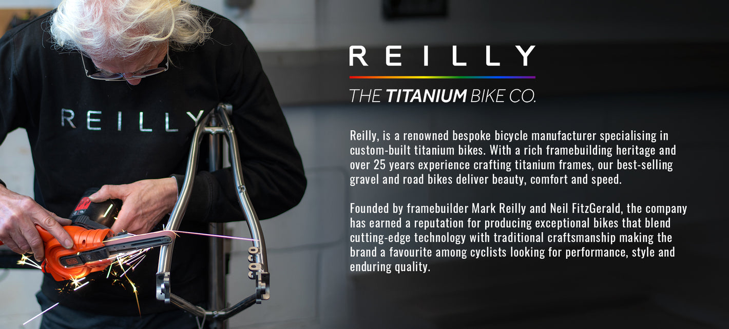 Person working on a bicycle frame with Reilly Titanium Bike Co branding.