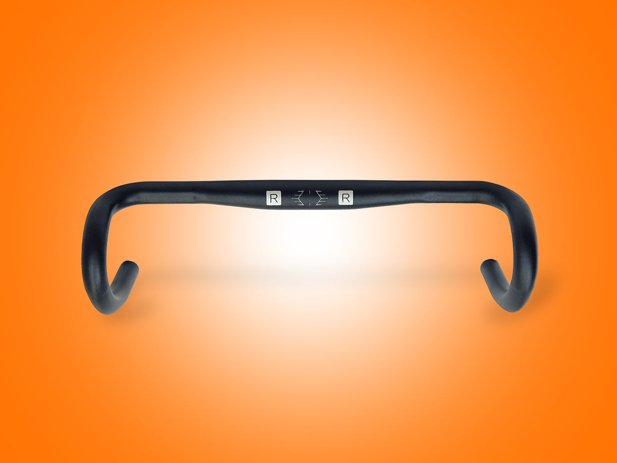 Black bicycle handlebar on an orange gradient background