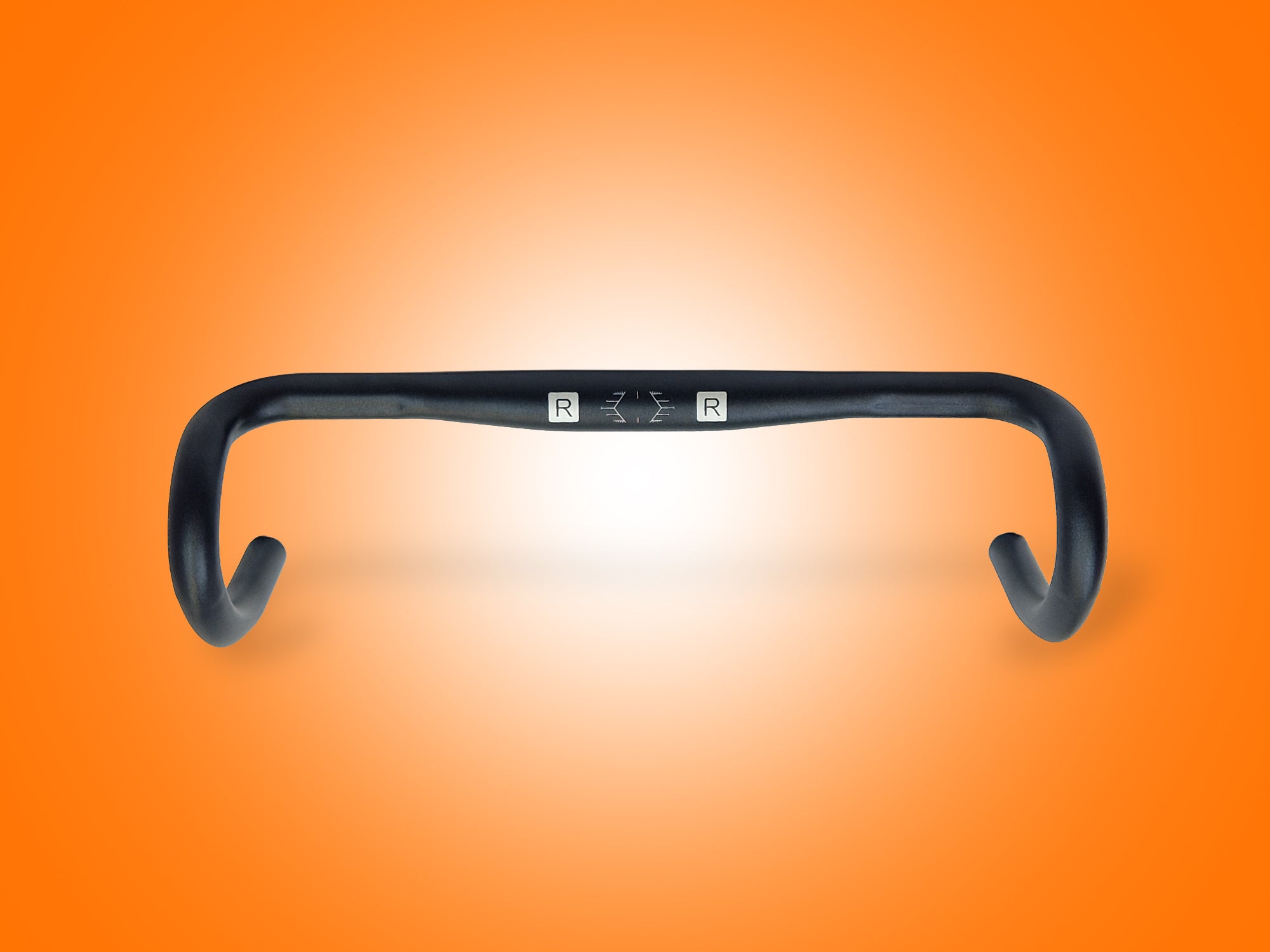Black bicycle handlebar on an orange gradient background