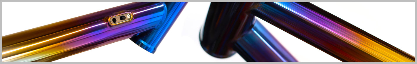 Close up of a custom rainbow fade coloured titanium bike frame