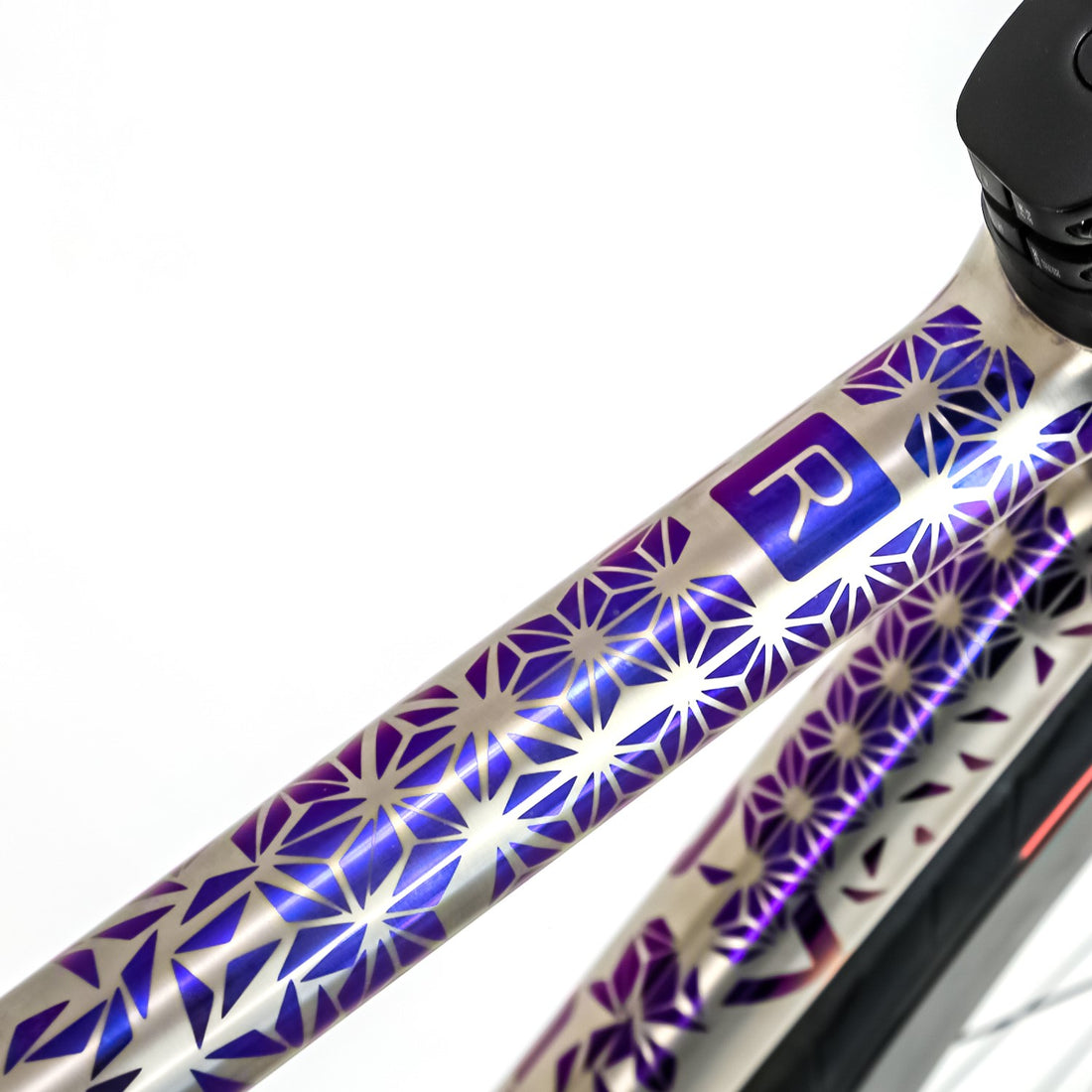 anodized blue triangle flowers on a titanium road bike 