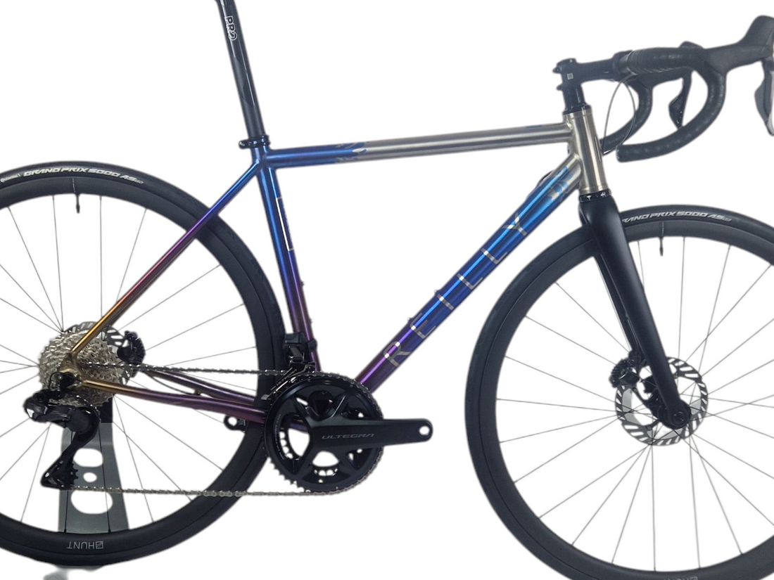 Bicycle with a blue frame and black components on a white background
