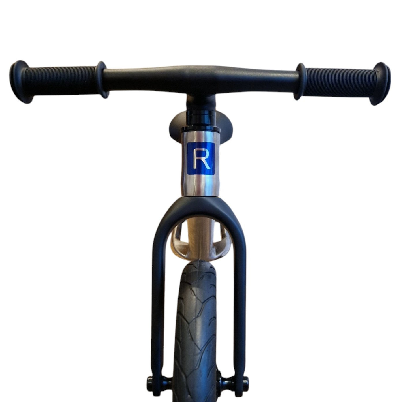 The front view of  titanium balance bike on white background.