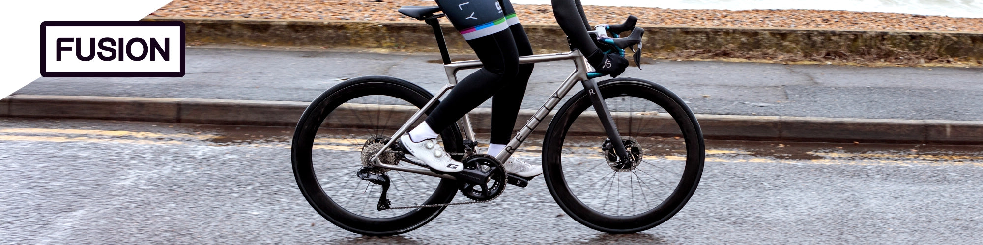 Person riding a bicycle on a road with 'Fusion' branding in the corner.