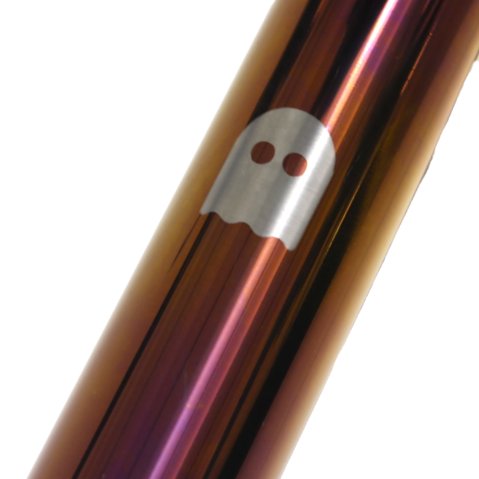 An anodised titanium bike top tube with a ghost shape printed onto it