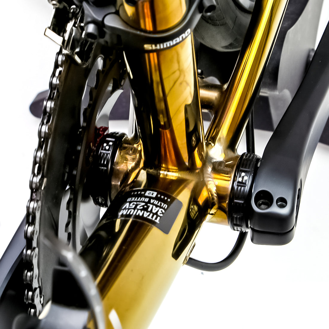 Polished gold Reilly road bike frame with chainset and bottom bracket