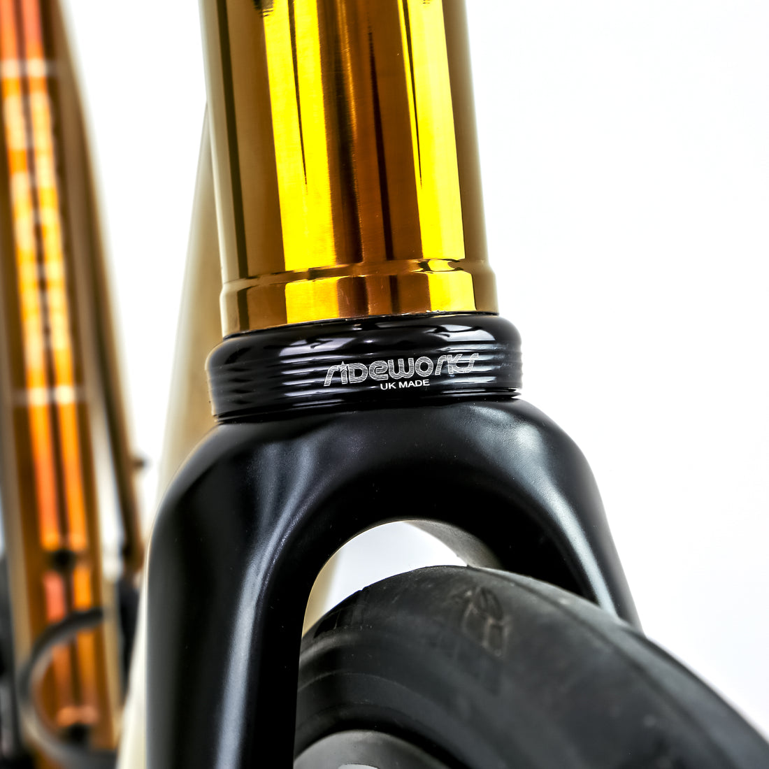 Polished gold Reilly road bike head tube with a RIDEWORKS headset