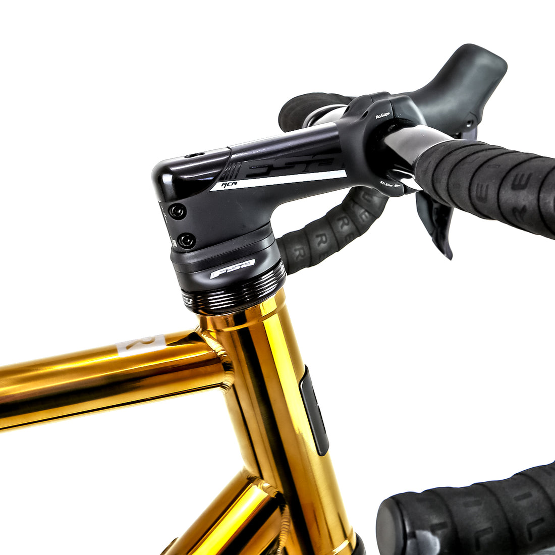 Polished gold Reilly road bike with FSA headset and aerodynamic handlebars