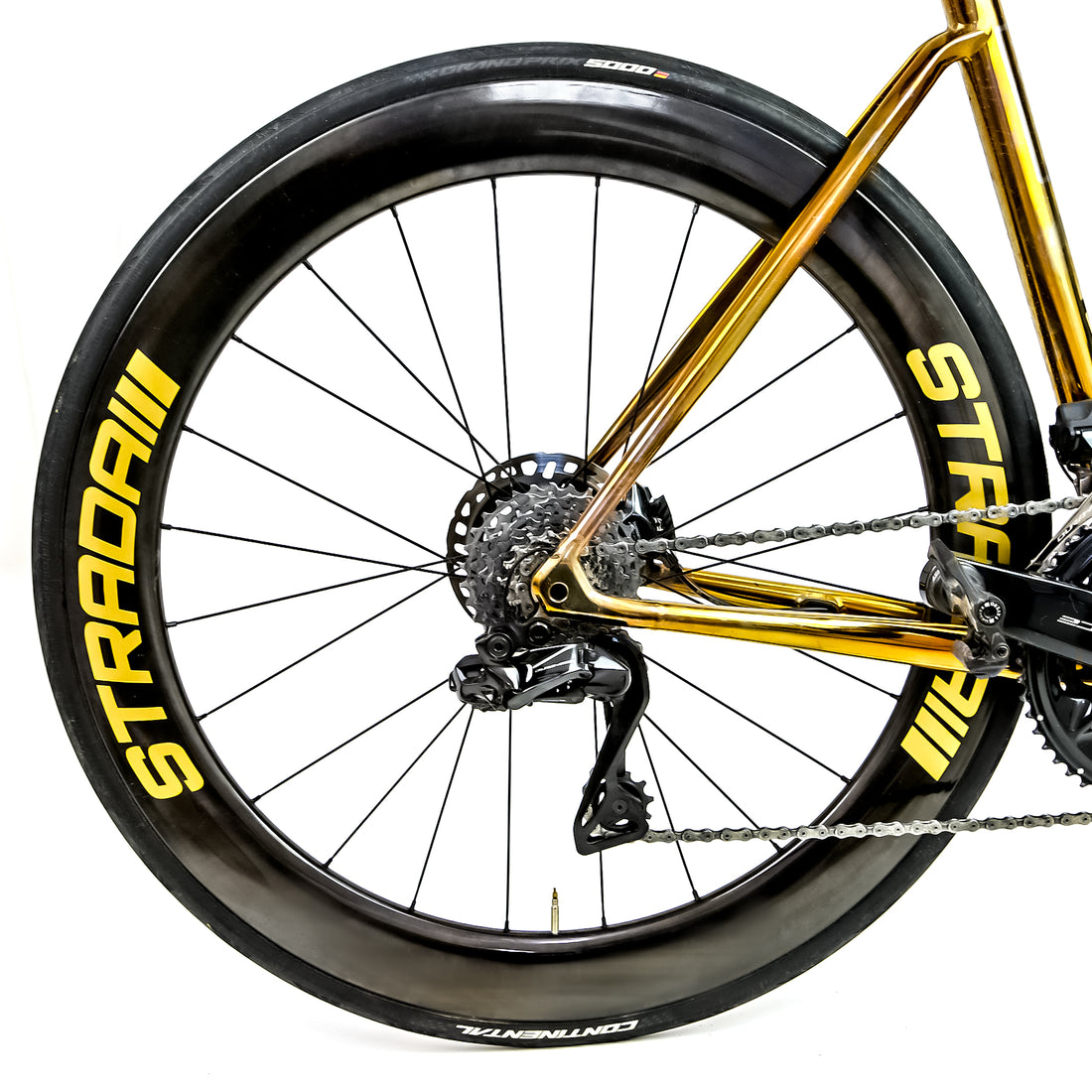 Polished gold Reilly road bike with golden Strada wheels