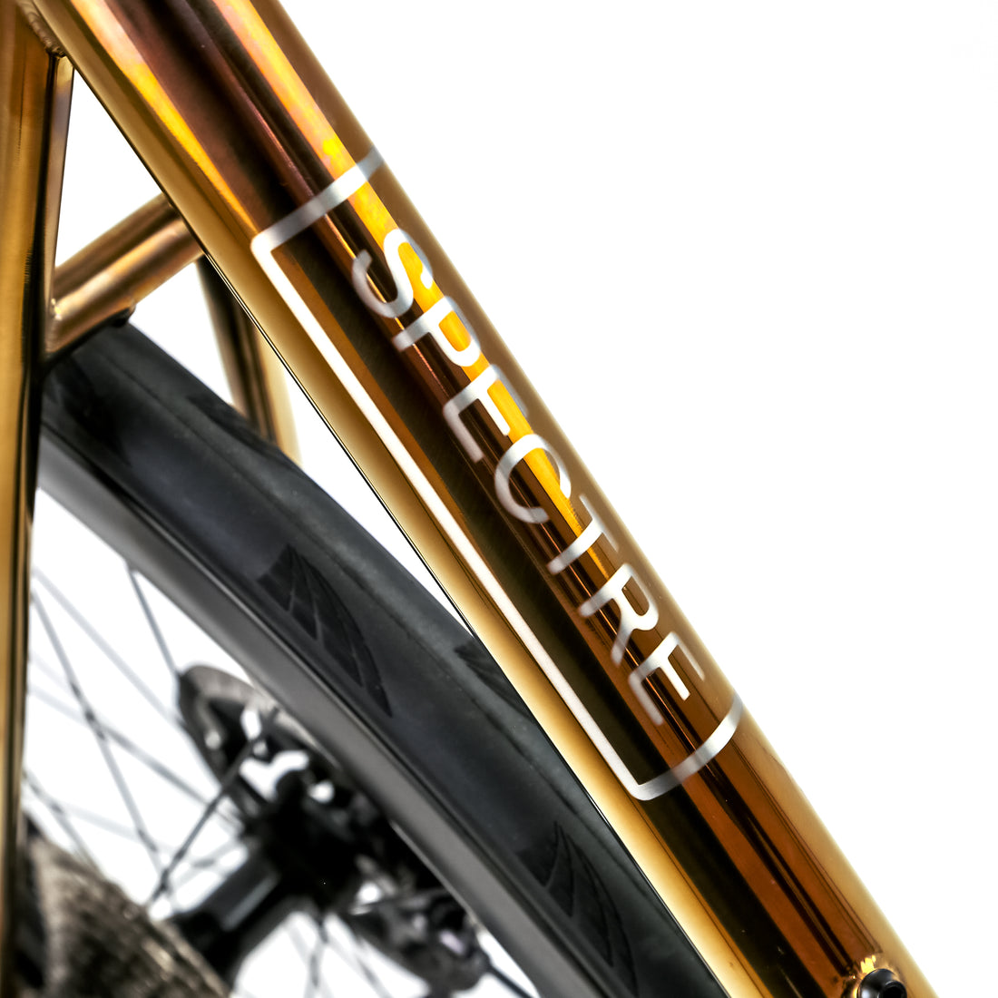 Polished gold Reilly road bike with  SPECTRE branding on seat tube 