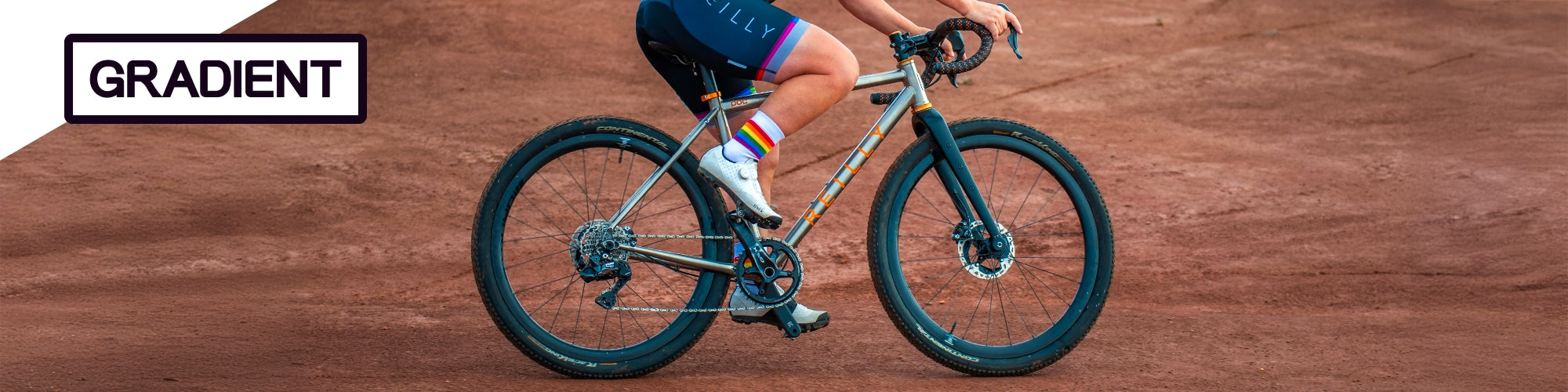 Person riding a bicycle on a gravel with 'Gradient' branding.