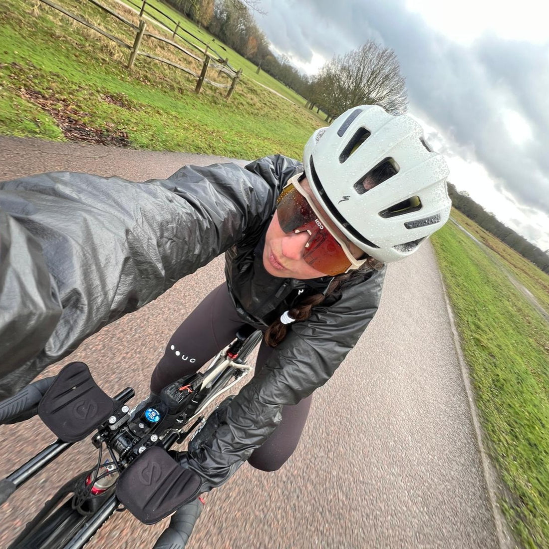 A cyclist shot from above cyles on a country road.