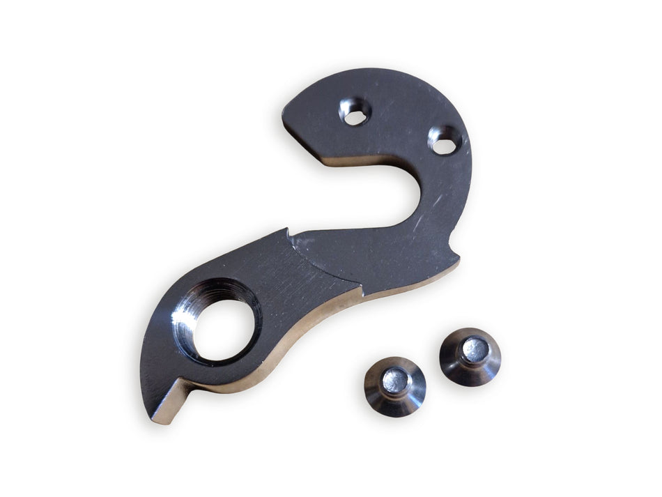 Metallic mechanical component with three smaller parts on a white background