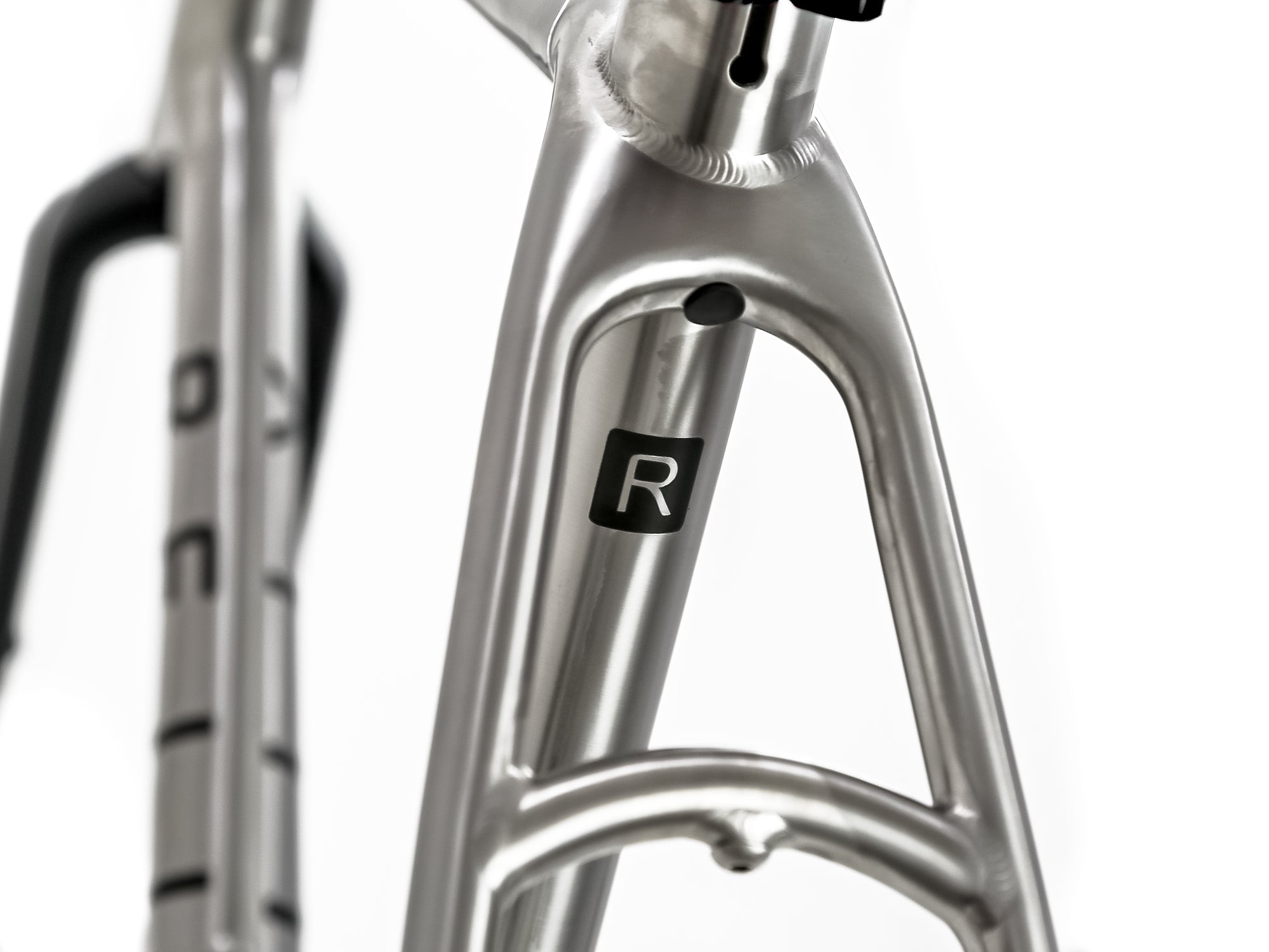 polished titanium bike frame with "R" Reilly logo 