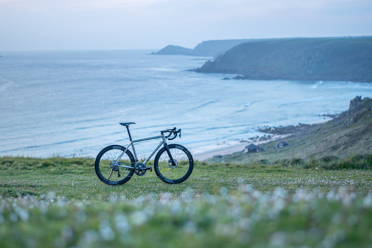A Reilly t640 titanium road bike near water and land formations