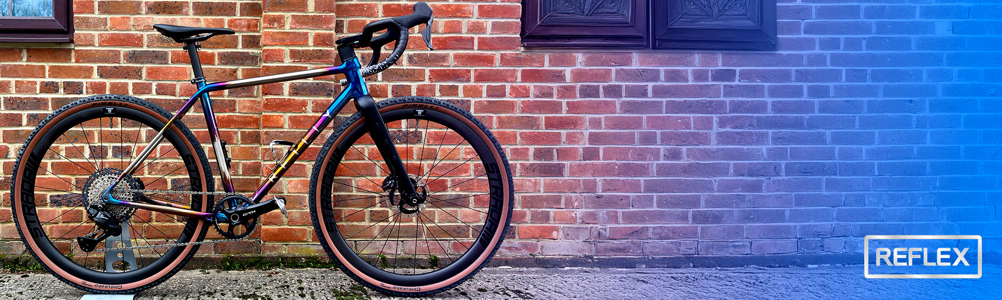 Bicycle leaning against a brick wall with 'Reflex' branding.