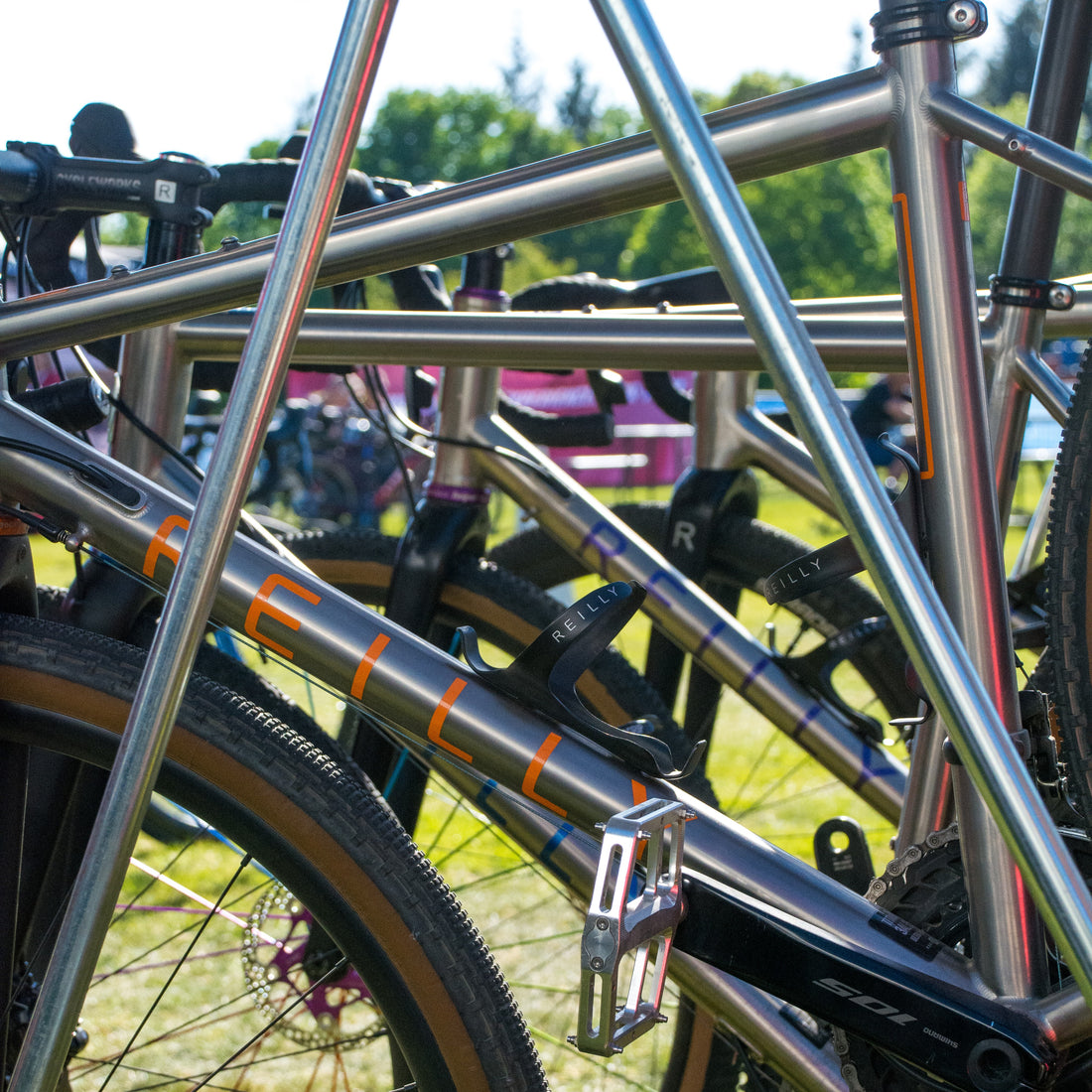 A rack with a numbr of titanium bikes.