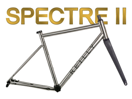 A metallic silver bicycle frame with a black fork, shown against a white background with a large gold 'SPECTRE II' text overlay at the top.