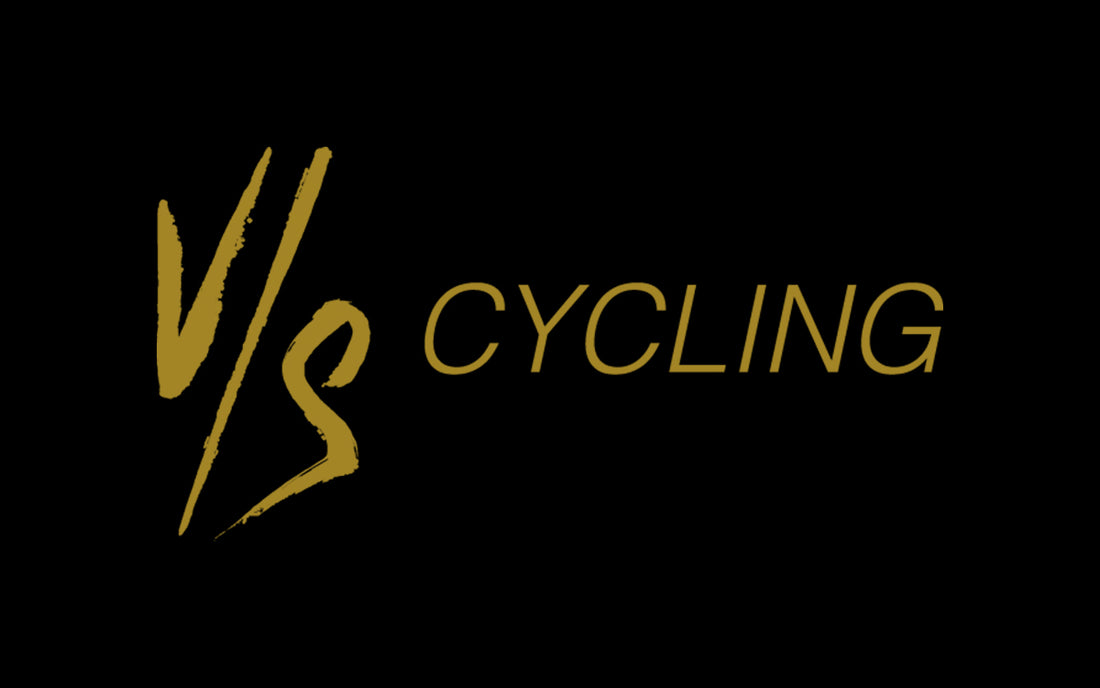 VS cycling logo in gold font on a black background.