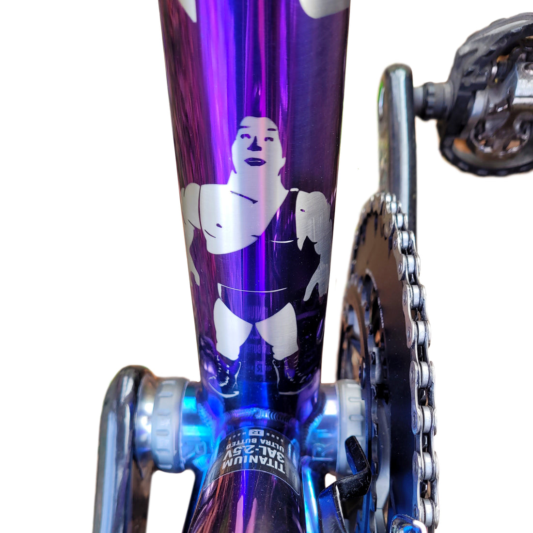 Strong man logo anodised onto a titanium bike frame. 