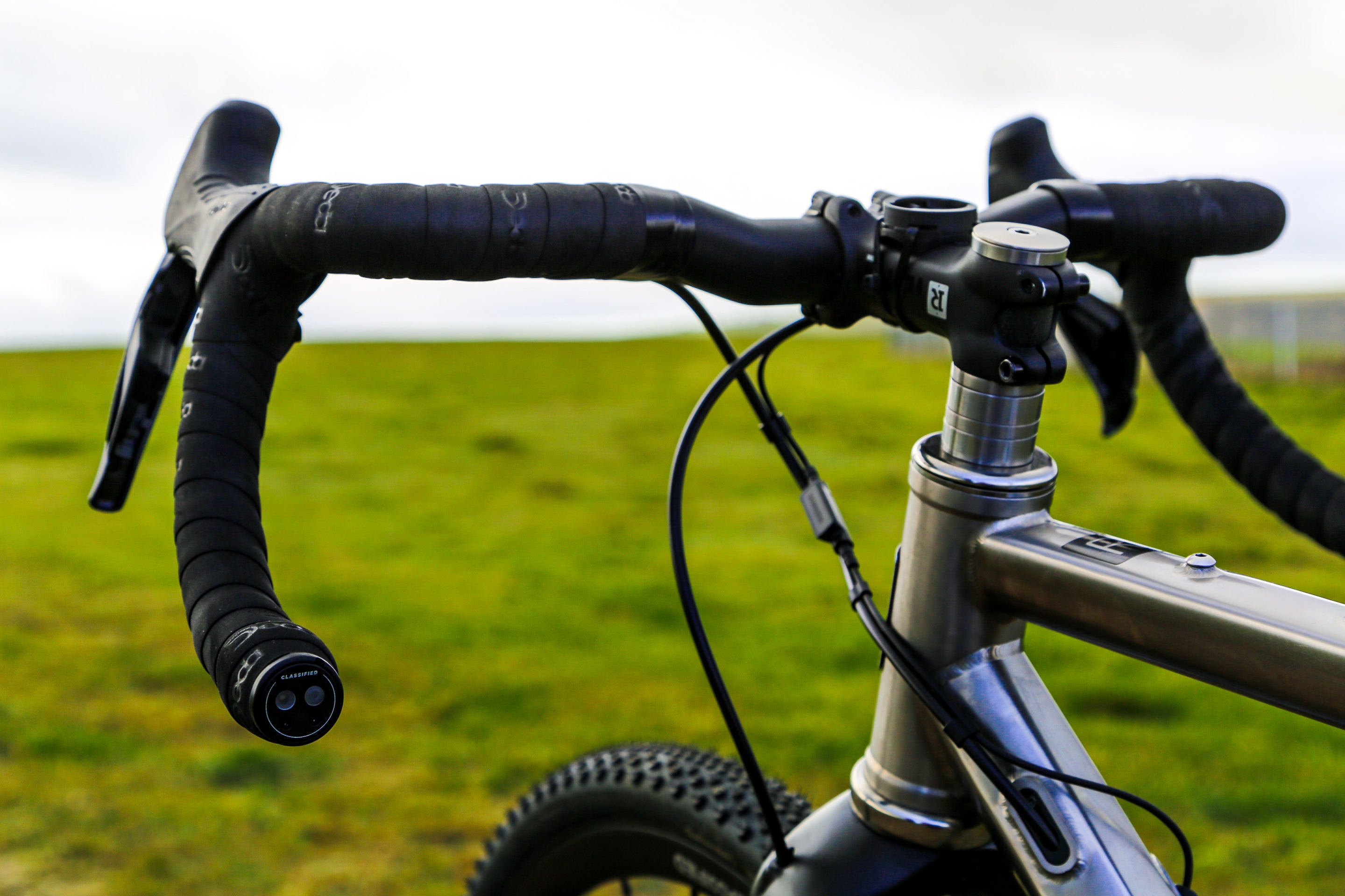 Close up of Reilly Handle bars on a green landscape.