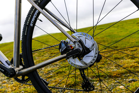 Close up of the wheels on a Reilly Bike on the green landcape