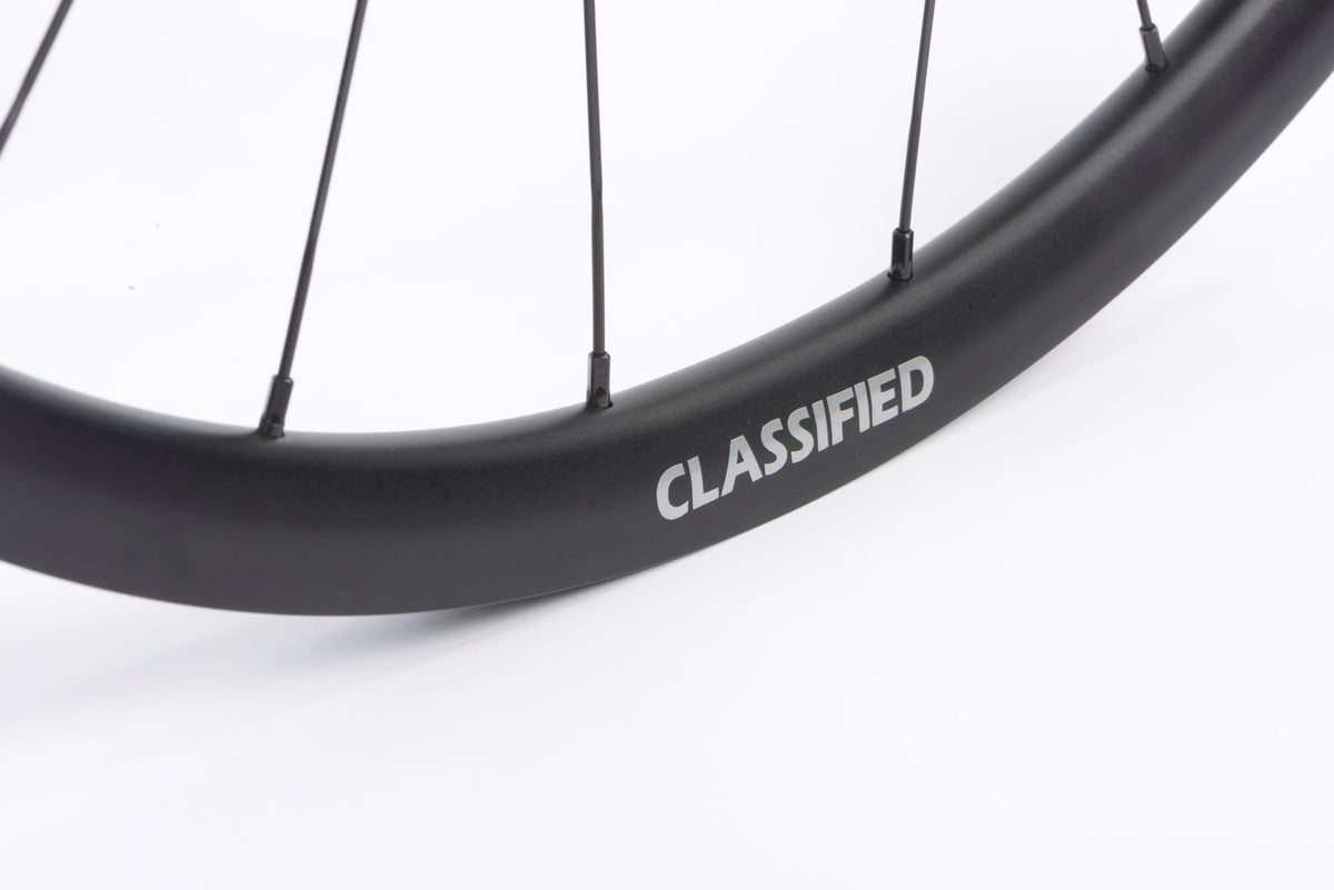 Close up of the Classifed logo on a wheel, on white background