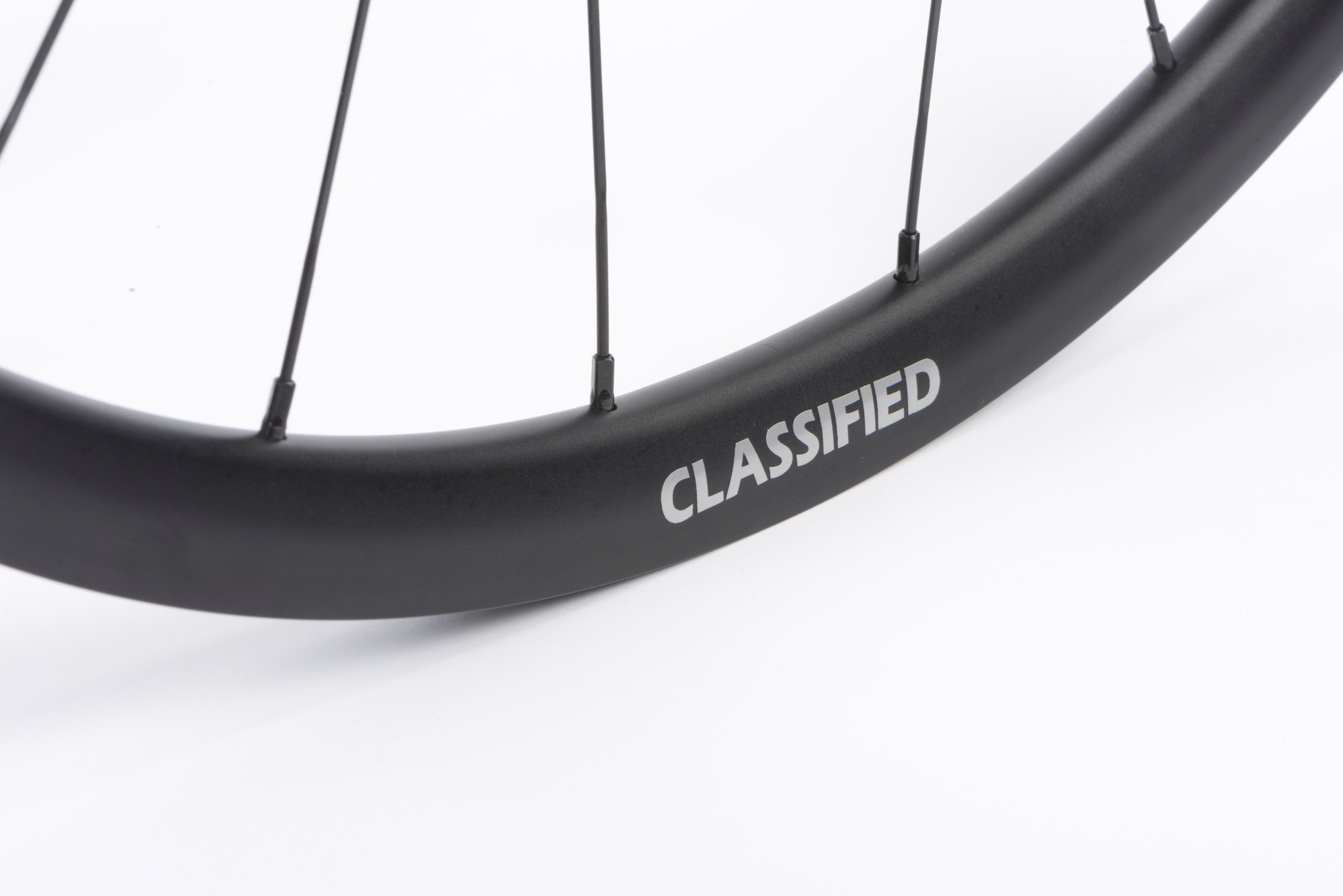 Close up of the Classifed logo on a wheel, on white background