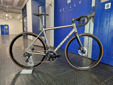 T325D full build with Reilly x DCR wheels standing outside Reilly's blure front door 