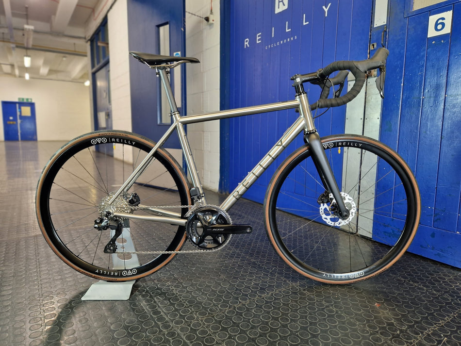 T325D full build with Reilly x DCR wheels standing outside Reilly's blure front door 